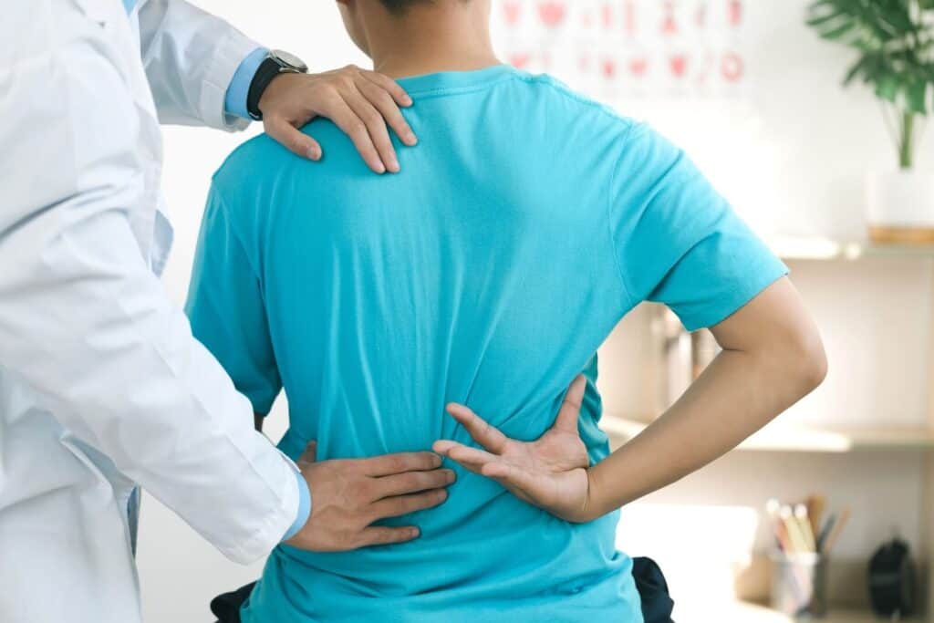 Chiropractor adjusting a man’s back  | What does a chiropractor do?