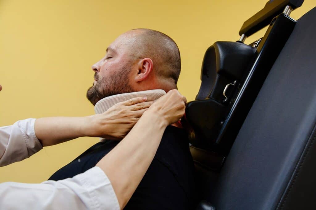 Man getting his neck adjusted by a chiropractor | Ways decompression therapy can help your spine