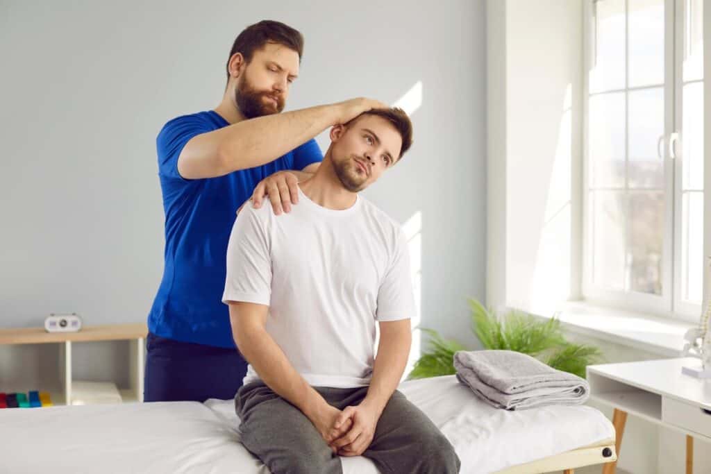 A chiropractor adjusting a patient's neck | Tips for getting rid of tech neck